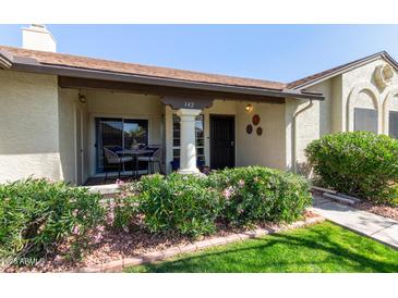 Inviting front porch featuring stylish seating and well-maintained landscaping at 8140 N 107Th Ave # 142, Peoria, AZ 85345