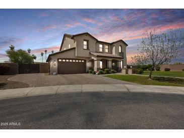 Inviting two-story home with a two-car garage, desert landscaping, and a charming tile roof at 890 W Zion Pl, Chandler, AZ 85248