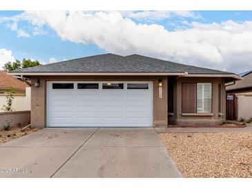Charming single-story home featuring a two-car garage, desert landscaping, and a neutral color palette at 1736 E Villa Maria Dr, Phoenix, AZ 85022