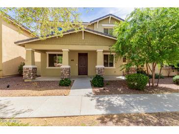 Charming two-story home featuring stone accents on the porch columns and a well-maintained front yard at 20733 W Alsap Rd, Buckeye, AZ 85396