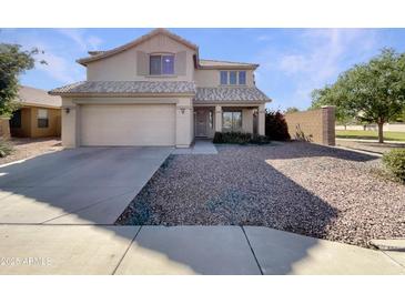 Two-story home features a well-maintained facade with a two car garage and a low maintenance front yard at 6602 S 23Rd Ave, Phoenix, AZ 85041
