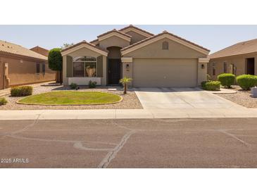 Charming single-story home with a desert landscape and well-maintained front yard at 10621 W Pima St, Tolleson, AZ 85353