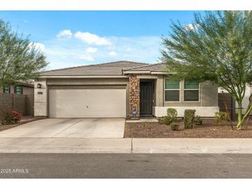 Charming single-story home with a well-maintained front yard and a two-car garage at 12374 W Locust Ln, Avondale, AZ 85323