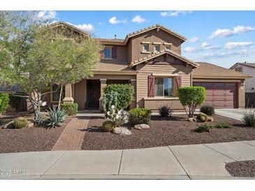 Charming two-story home with manicured desert landscaping, a spacious garage, and a welcoming front entrance at 18585 E Ryan Rd, Queen Creek, AZ 85142