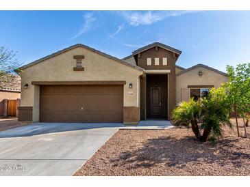 Charming single-story home with a two-car garage and well-maintained landscaping at 23789 W Chipman Rd, Buckeye, AZ 85326