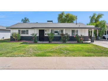Charming single-story home featuring a landscaped front yard and a welcoming entrance at 3009 E Whitton Ave, Phoenix, AZ 85016