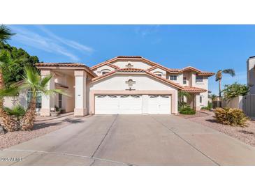 Charming two-story home showcasing a three-car garage, landscaped yard and a classic Southwest style at 3112 N 110Th Ave, Avondale, AZ 85392
