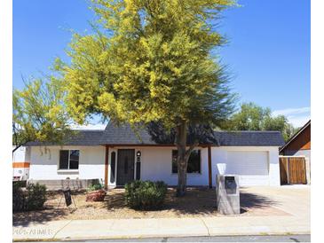 Charming single-story home featuring desert landscaping, a black roof, and a cozy covered entryway at 3514 W Altadena Ave, Phoenix, AZ 85029