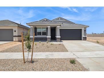 Charming single-story home with a gray color palette, a well-kept yard and a two car garage at 46378 W Lander Ln, Maricopa, AZ 85139