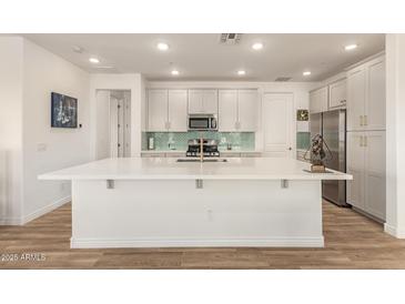 Bright, open kitchen boasts an oversized island, stainless appliances, and modern finishes at 5100 E Rancho Paloma Dr # 2078, Cave Creek, AZ 85331