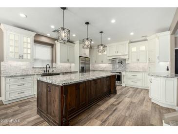 Spacious kitchen featuring a large center island, stainless steel appliances, and custom cabinetry at 1051 E Julie Ave, San Tan Valley, AZ 85140