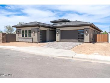 Modern home with desert landscaping, multiple-car garage, and neutral color palette at 1336 E Cherrywood Pl, Chandler, AZ 85249