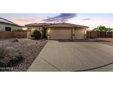 Charming single-story home with a three-car garage and desert landscaping for low maintenance at 17696 N 168Th Dr, Surprise, AZ 85374
