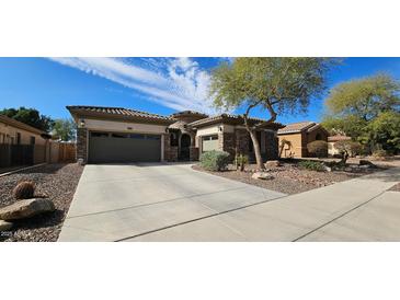 Charming home with a two-car garage, desert landscaping, and neutral paint scheme at 19245 W Pasadena Ave, Litchfield Park, AZ 85340