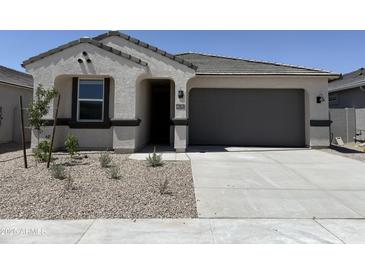 Charming single-story home featuring a two-car garage and low-maintenance desert landscaping at 46392 W Lander Ln, Maricopa, AZ 85139