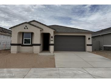 Charming single-story home with a two-car garage and a neutral color palette at 46392 W Lander Ln, Maricopa, AZ 85139
