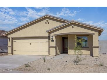 Charming single-story home featuring desert landscaping and a two-car garage at 1102 W West Virginia Ave, Florence, AZ 85132