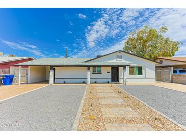 Charming single-story home with drought-tolerant landscaping and covered carport at 1510 W 7Th Dr, Mesa, AZ 85202