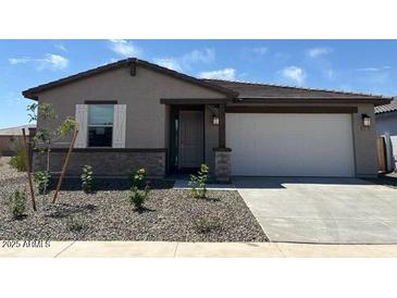 Charming single-story home featuring neutral paint, desert landscaping, and an attached two-car garage at 16071 W Remuda Dr, Surprise, AZ 85387