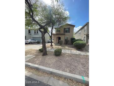 Traditional home with a desert landscaped front yard and arched entry at 22074 S 211Th St, Queen Creek, AZ 85142