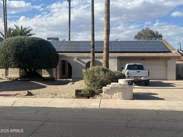 Charming single-story home featuring solar panels and a well-manicured front yard at 2324 E Cortez St, Phoenix, AZ 85028
