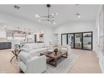 Inviting living room with open kitchen view and access to the backyard at 2546 E Roma Ave, Phoenix, AZ 85016