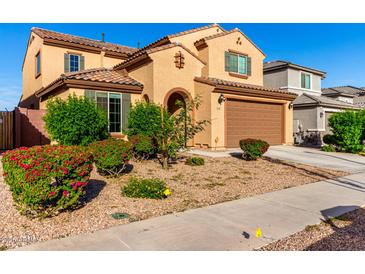 Two-story home featuring a lovely landscaped yard, covered entry, and two-car garage at 25627 N 163Rd Dr, Surprise, AZ 85387