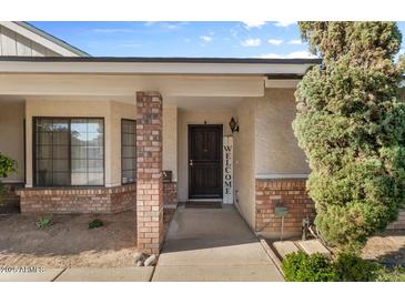 Charming front door with brick columns and a welcoming entrance with a vertical welcome sign at 2616 E Des Moines St, Mesa, AZ 85213
