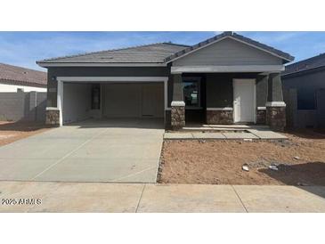 New construction home featuring an open garage and low maintenance desert landscaping at 3929 E San Jose St, San Tan Valley, AZ 85143