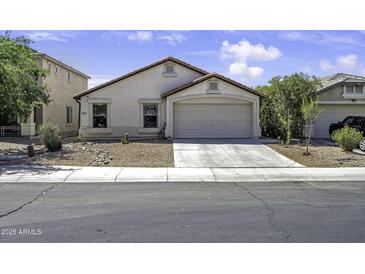Charming single-story home with a two-car garage and desert landscaping in front yard at 40845 W Thornberry Ln, Maricopa, AZ 85138