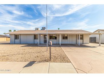 Charming single-story home with a low-maintenance gravel front yard and a covered carport at 4343 E Union Hills Dr, Phoenix, AZ 85050