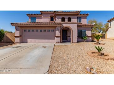 Two-story home with attached garage and desert landscaping at 4826 S 26Th Ln, Phoenix, AZ 85041