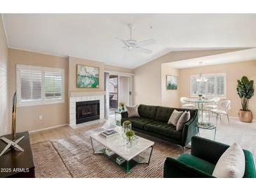 Updated living room space with modern decor, neutral colors, and a cozy fireplace at 9736 N 95Th St # 225, Scottsdale, AZ 85258