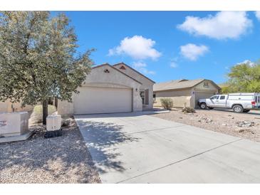 Well-maintained single-story home with a two-car garage and low-maintenance landscaping at 43849 W Cowpath Rd, Maricopa, AZ 85138