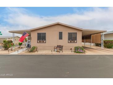 Inviting single-story home with covered parking and tidy desert landscaping at 11596 W Sierra Dawn Blvd # 307, Surprise, AZ 85378