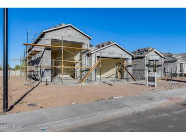 View of home under construction with scaffolding and building materials at 14723 N 73Rd Dr, Peoria, AZ 85381