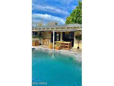 Backyard pool and covered patio area perfect for outdoor dining and entertaining at 2938 N 18Th Ave, Phoenix, AZ 85015