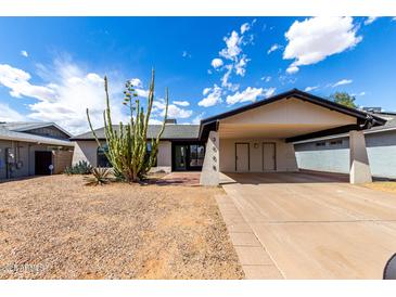 Charming single-story home with desert landscaping and a covered two-car carport at 3008 W Michigan Ave, Phoenix, AZ 85053