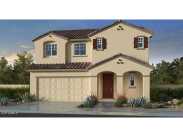 Charming two-story home with neutral paint, detailed shutters, and landscaped front yard at 10168 W Vale Dr, Avondale, AZ 85392