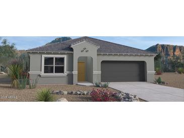Charming single-story home boasts a neutral color palette, desert landscaping, and a two-car garage at 1314 W Kennedy Ave, Coolidge, AZ 85128