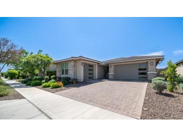 Charming single-story home with a well-manicured lawn and a spacious driveway at 14637 W Wethersfield Rd, Surprise, AZ 85379