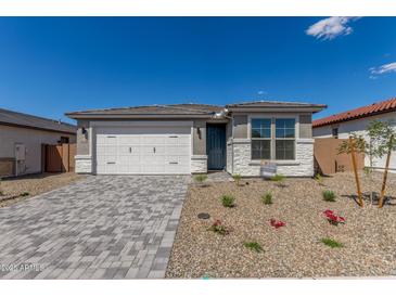 Charming single-story home features a brick driveway and neutral stone accents at 18498 E Dario Rd, Gold Canyon, AZ 85118