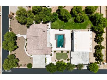 An aerial view of a home with a pool, putting green, and meticulously landscaped backyard at 21615 E Pegasus Pkwy, Queen Creek, AZ 85142