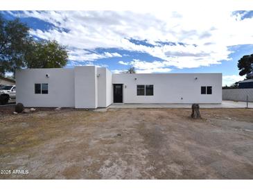 This home boasts a freshly painted white exterior with multiple windows providing ample natural light at 6813 W Sherri Jean Ln, Peoria, AZ 85382