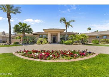 Charming home features a circular driveway with beautiful flower bed and an inviting front entrance at 7272 N 71St St, Paradise Valley, AZ 85253