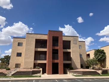 Inviting multi-story condo building featuring private balconies and a well-maintained landscape at 1340 N Recker Rd # 224, Mesa, AZ 85205