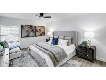 Beautifully staged main bedroom with stylish furnishings, decor, and a ceiling fan at 3416 N 44Th St # 51, Phoenix, AZ 85018