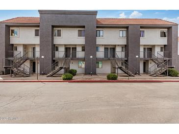 View of apartment building with multiple units, stairs leading to entry doors, and a red tile roof at 1215 E Lemon St # 222, Tempe, AZ 85281