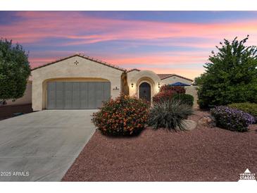 Charming single-story home with beautiful desert landscaping and a well-manicured lawn at 12738 W Nogales Dr, Sun City West, AZ 85375