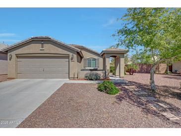Inviting single-story home featuring a low maintenance yard, covered porch entry, and attached two car garage at 18590 W Vogel Ave, Goodyear, AZ 85338